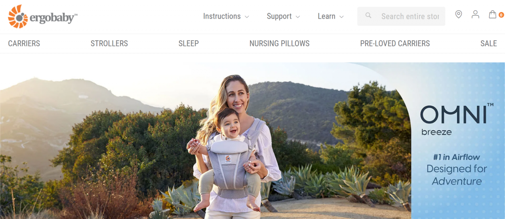 A page on the Ergobaby website showcasing their baby carrier Omni breeze with a photo of a woman holding a baby using the product.